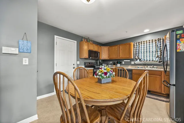 a view of a dining room with furniture and a kitchen view