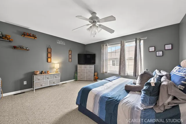 a bedroom with a bed and ceiling fan