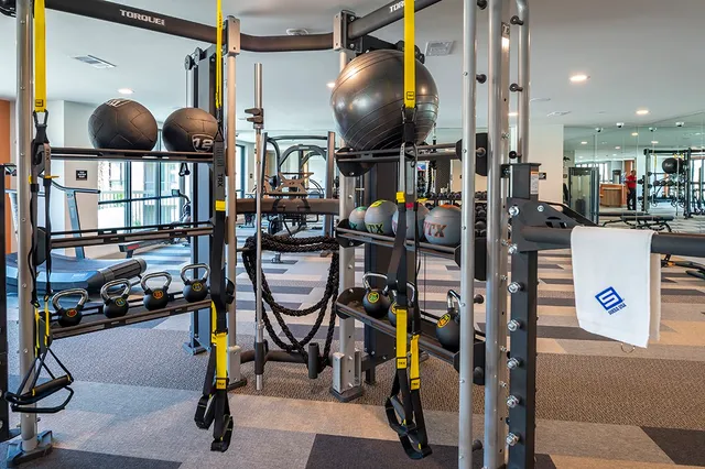 a gym room with lots of gym equipment