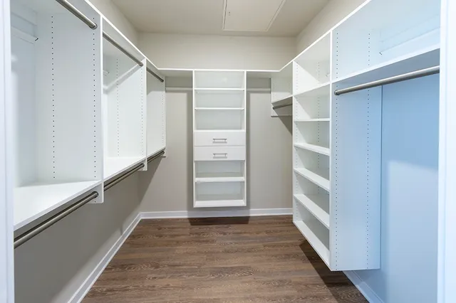 a view of walk in closet with empty racks