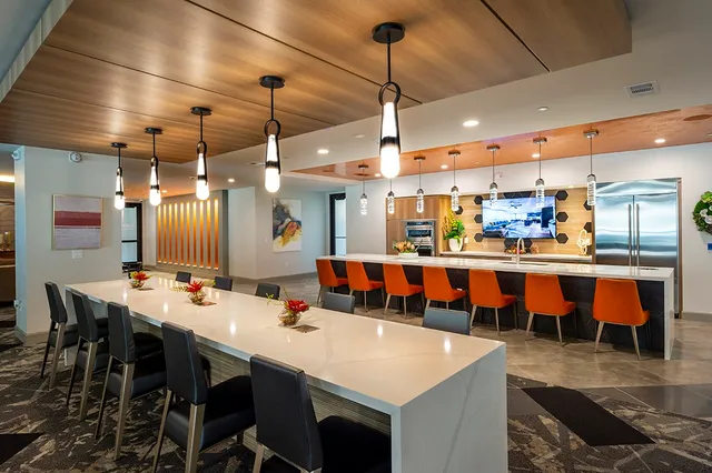 a large kitchen with a table and chairs