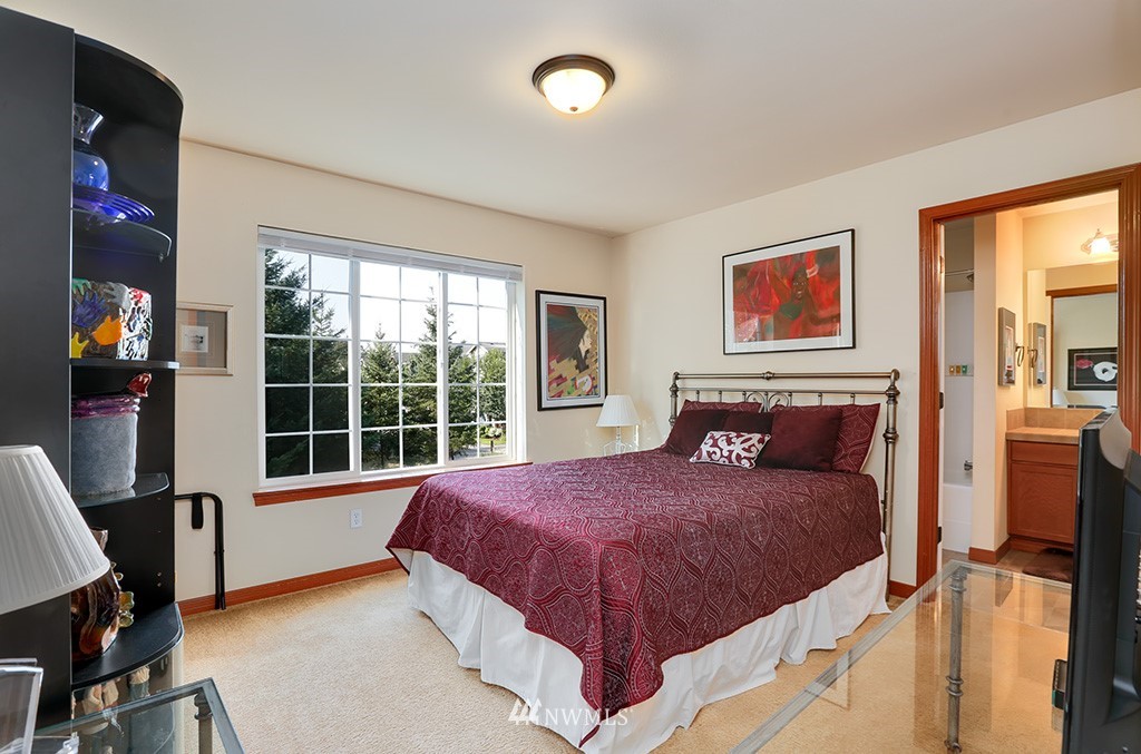 17801 20th Avenue Southeast Bothell, WA 98012 - Photo 14 of 25 a bedroom with a bed and dresser with windows