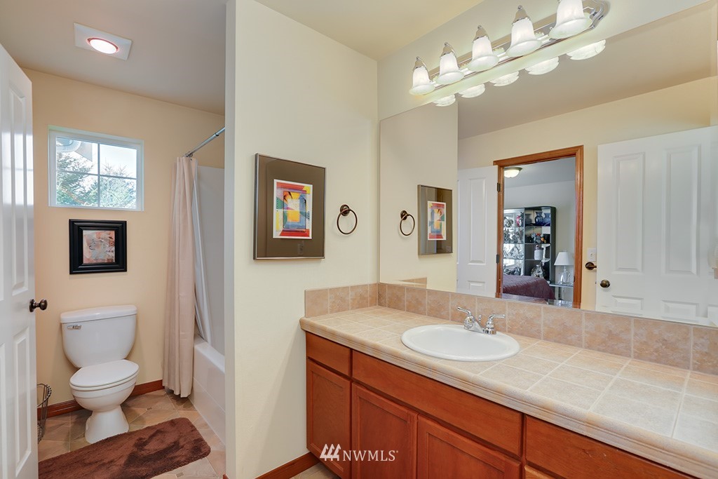 17801 20th Avenue Southeast Bothell, WA 98012 - Photo 15 of 25 a bathroom with a sink a toilet and a mirror