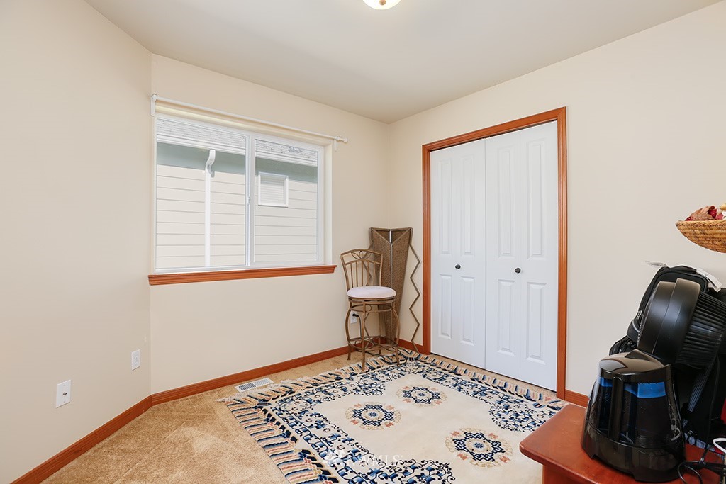 17801 20th Avenue Southeast Bothell, WA 98012 - Photo 16 of 25 a bedroom with a bed and wooden floor