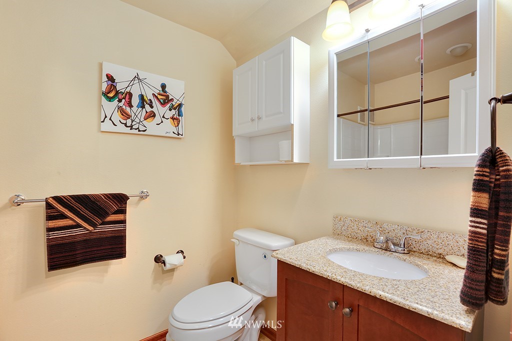 17801 20th Avenue Southeast Bothell, WA 98012 - Photo 18 of 25 a bathroom with a granite countertop sink and a mirror