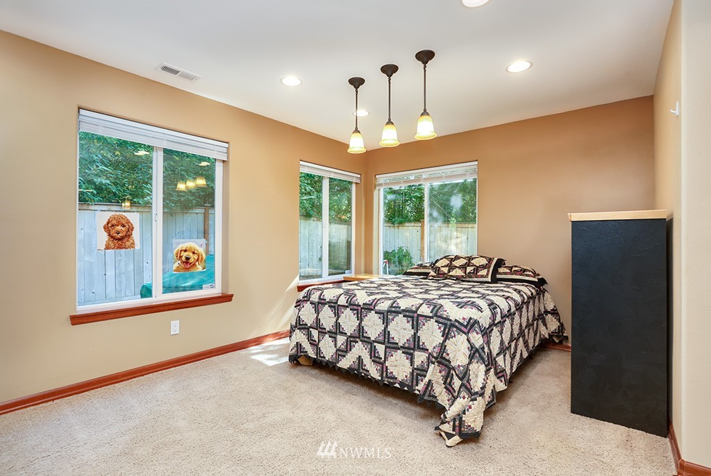 17801 20th Avenue Southeast Bothell, WA 98012 - Photo 20 of 25 a bed sitting in a spacious bedroom next to a window
