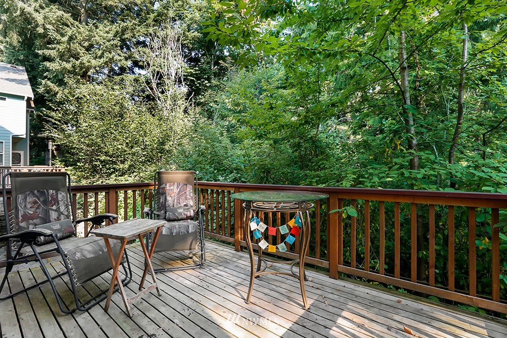 17801 20th Avenue Southeast Bothell, WA 98012 - Photo 22 of 25 a balcony with wooden floor outdoor seating and yard in the back