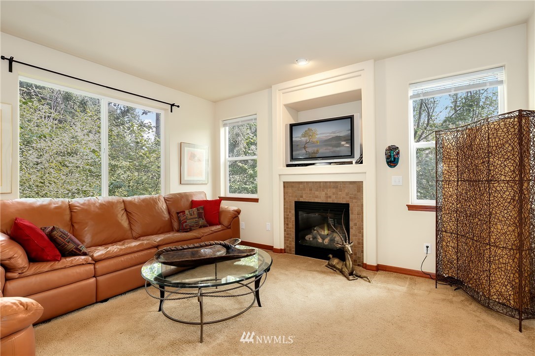 17801 20th Avenue Southeast Bothell, WA 98012 - Photo 4 of 25 a living room with furniture a flat screen tv and a fireplace