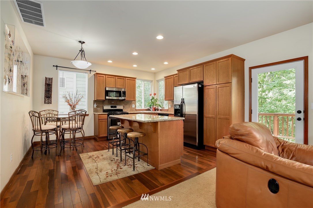 17801 20th Avenue Southeast Bothell, WA 98012 - Photo 5 of 25 a living room with furniture a dining table and chairs with kitchen view