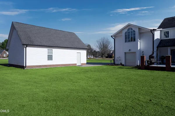 a kitchen with kitchen island granite countertop wooden cabinets a sink and stainless steel appliances