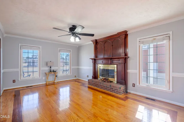 a view of a room with wooden floor and a window