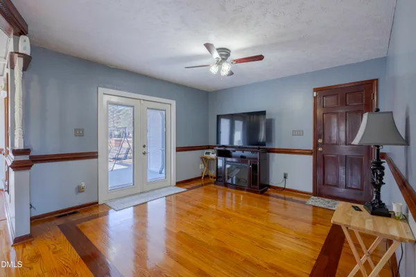 a view of room with window ceiling fan and hardwood floor