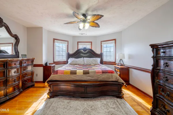 a bedroom with a bed and a chandelier