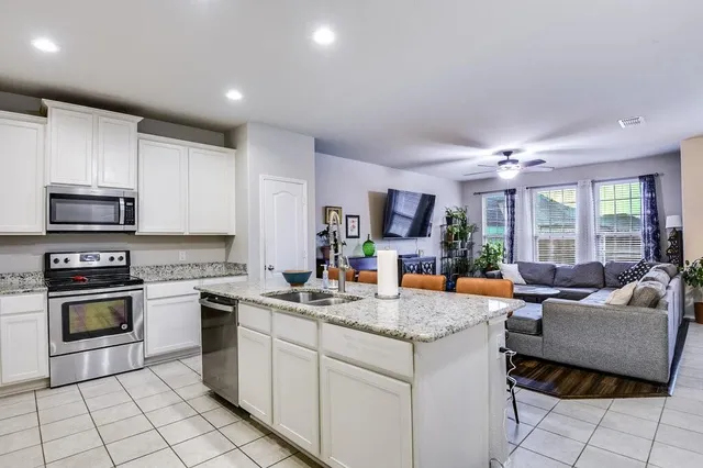 an aerial view of a houses with a swimming pool