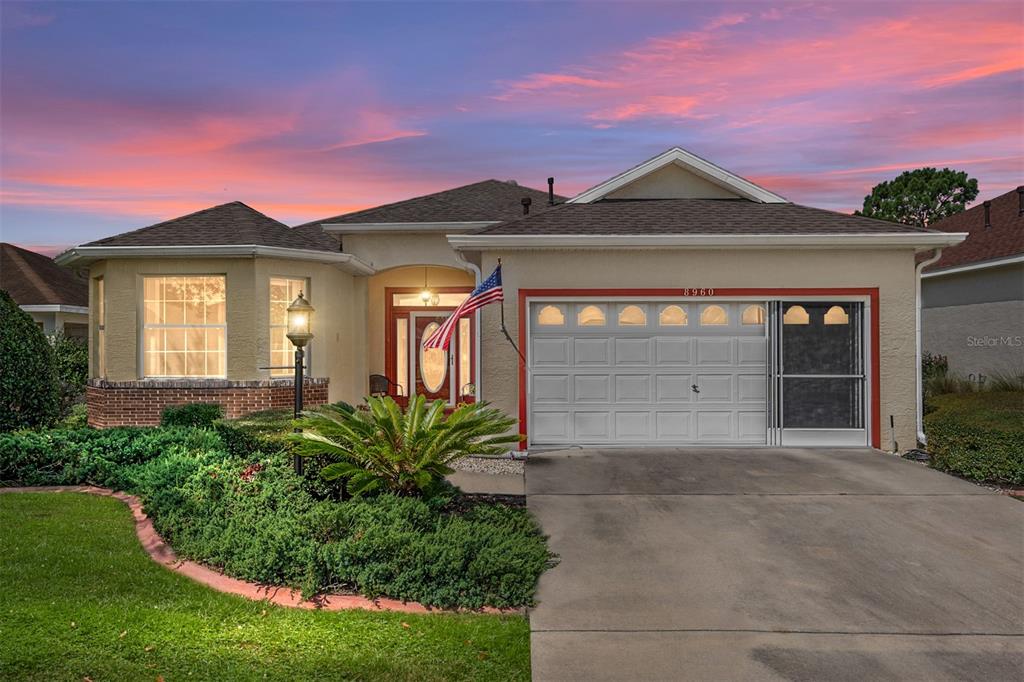 8960 Southwest 98th Avenue Ocala, FL 34481 - Photo 1 of 1 a front view of a house with a yard and garage