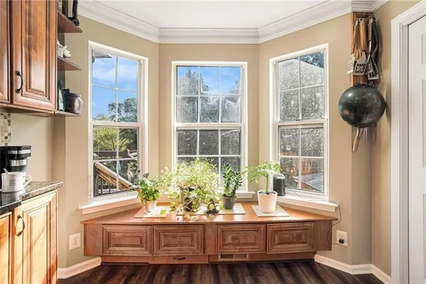 a bathroom with a granite countertop double vanity sink a mirror and a window