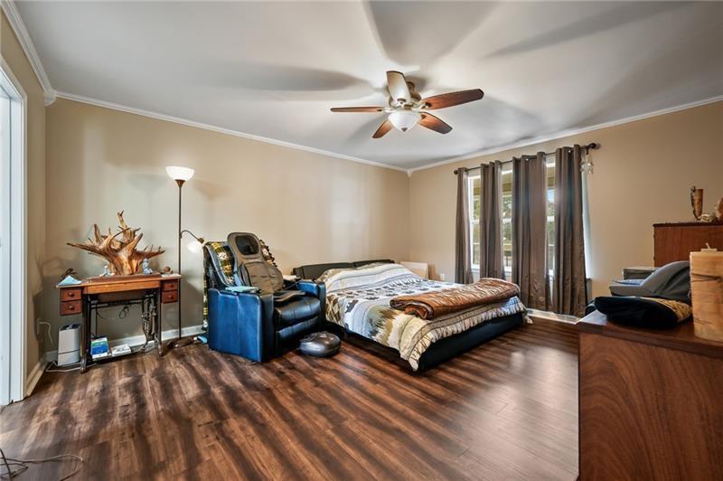 5303 Meadows Lake Crossing Southwest Powder Springs, GA 30127 - Photo 15 of 53 a bedroom with a bed and wooden floor