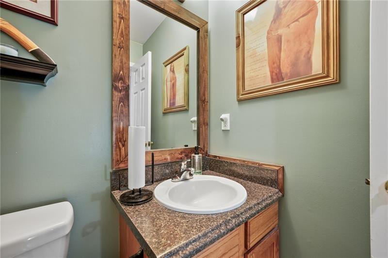5303 Meadows Lake Crossing Southwest Powder Springs, GA 30127 - Photo 16 of 53 a bathroom with a granite countertop sink a toilet and a mirror