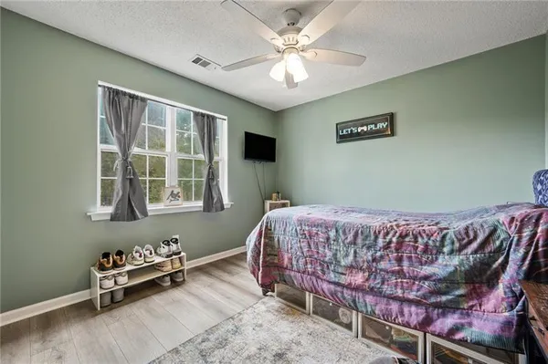 a bed room with a bed and a television