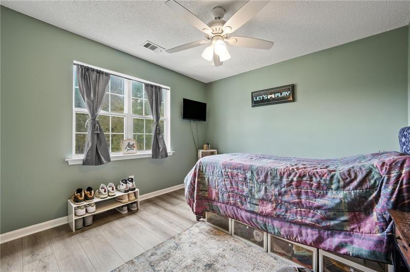 5303 Meadows Lake Crossing Southwest Powder Springs, GA 30127 - Photo 17 of 53 a bedroom with bed and a window