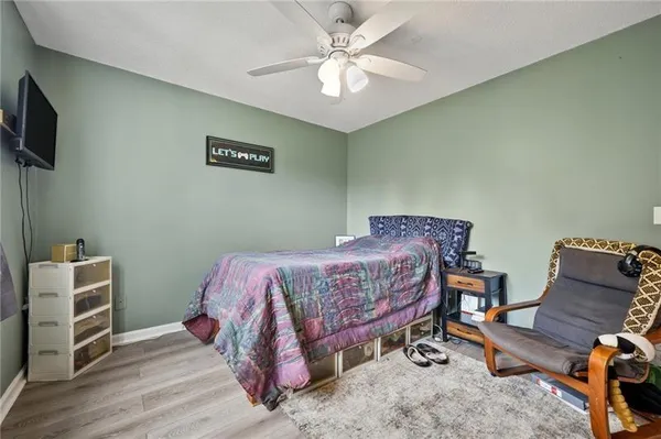 a bedroom with a bed a desk and chair