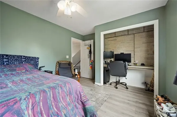 a bedroom with a bed and a large window