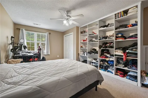 a bedroom with a bed and window