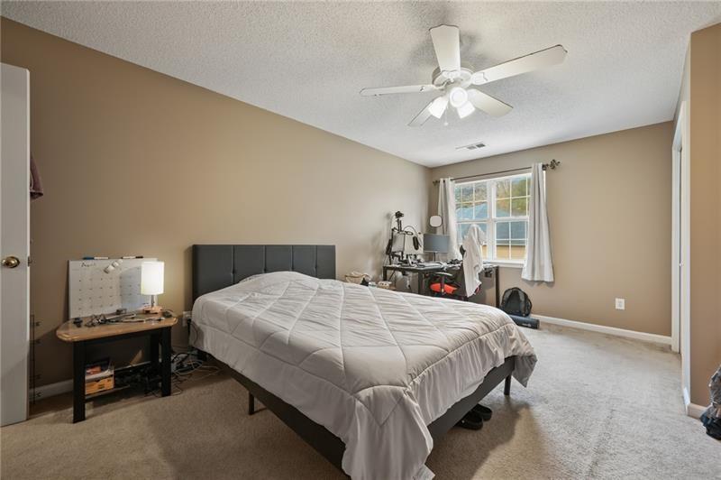 5303 Meadows Lake Crossing Southwest Powder Springs, GA 30127 - Photo 24 of 53 a bedroom with a bed and window