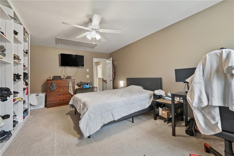 5303 Meadows Lake Crossing Southwest Powder Springs, GA 30127 - Photo 25 of 53 a bedroom with a bed a flat screen tv and dresser