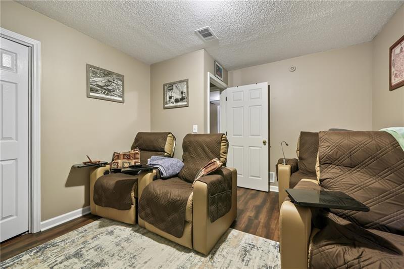 5303 Meadows Lake Crossing Southwest Powder Springs, GA 30127 - Photo 28 of 53 a living room with furniture and a couch