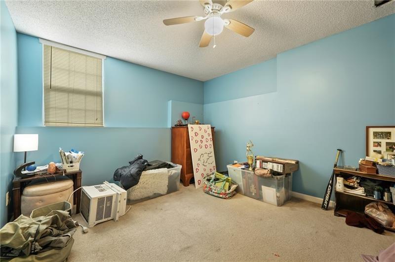 5303 Meadows Lake Crossing Southwest Powder Springs, GA 30127 - Photo 29 of 53 a room with furniture and chandelier