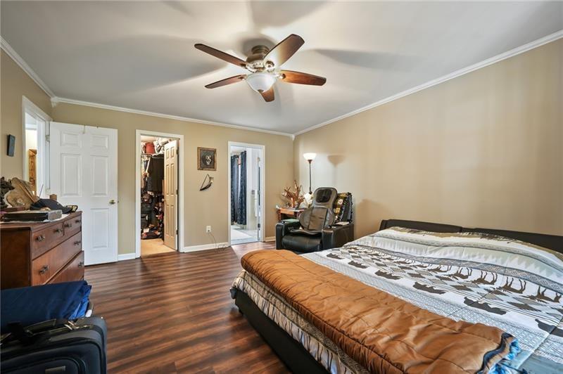 5303 Meadows Lake Crossing Southwest Powder Springs, GA 30127 - Photo 31 of 53 a bedroom with a bed and wooden floor