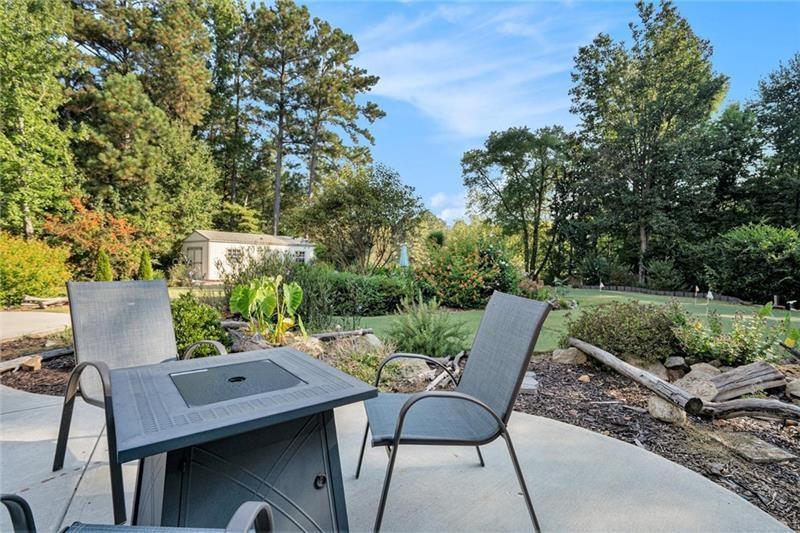5303 Meadows Lake Crossing Southwest Powder Springs, GA 30127 - Photo 37 of 53 a backyard of a house with table and chairs