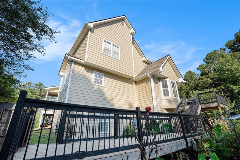 5303 Meadows Lake Crossing Southwest Powder Springs, GA 30127 - Photo 40 of 53 a view of a house with a small yard and wooden fence