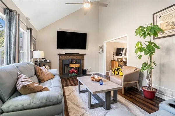 a living room with furniture a flat screen tv and a fireplace