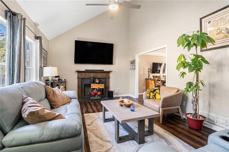 5303 Meadows Lake Crossing Southwest Powder Springs, GA 30127 - Photo 4 of 53 a living room with furniture a flat screen tv and a fireplace