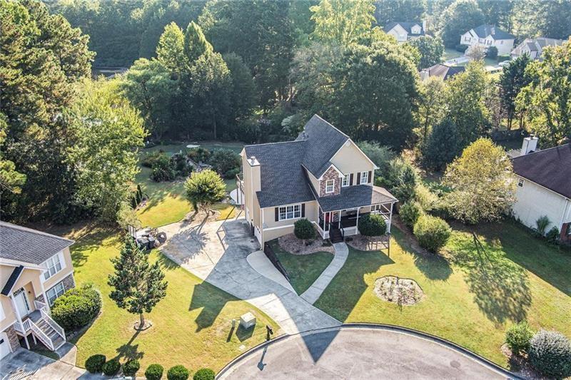 5303 Meadows Lake Crossing Southwest Powder Springs, GA 30127 - Photo 50 of 53 an aerial view of a house with swimming pool and garden