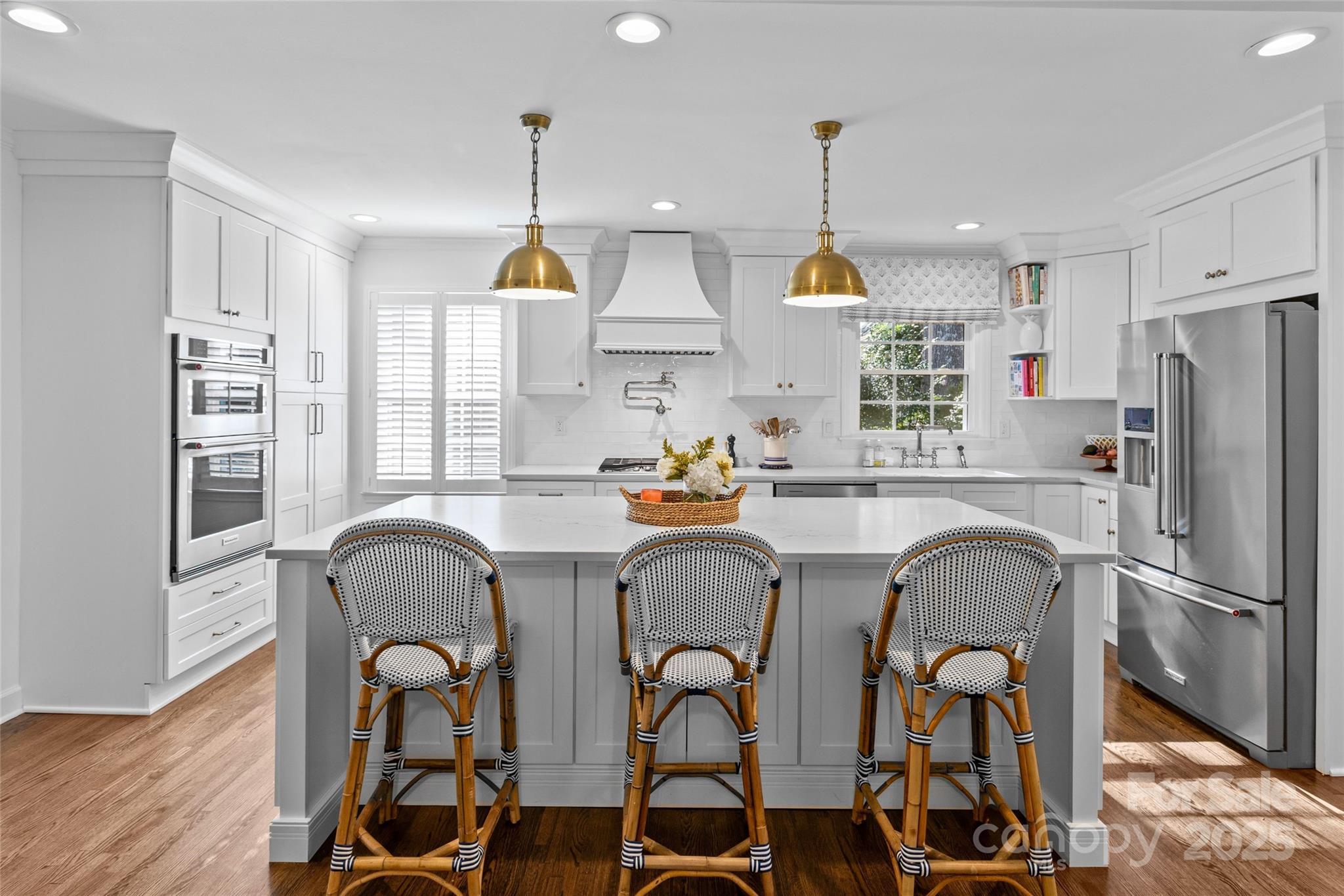7526 Whistlestop Road Charlotte, NC 28210 - Photo 14 of 42 a kitchen with stainless steel appliances a dining table chairs sink refrigerator and microwave
