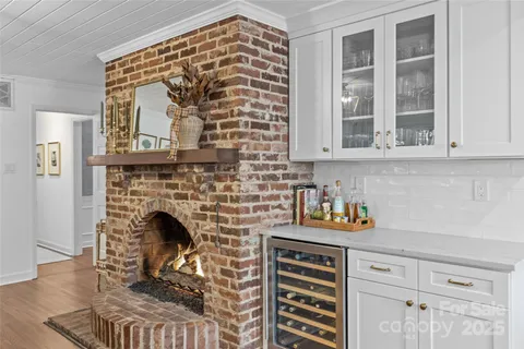 a kitchen with a stove and a fireplace