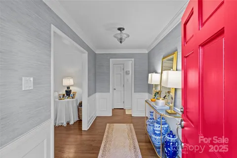a view of a bedroom with furniture and wooden floor