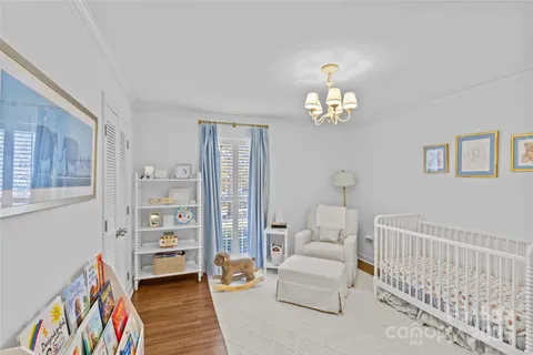 a bedroom with furniture and a chandelier
