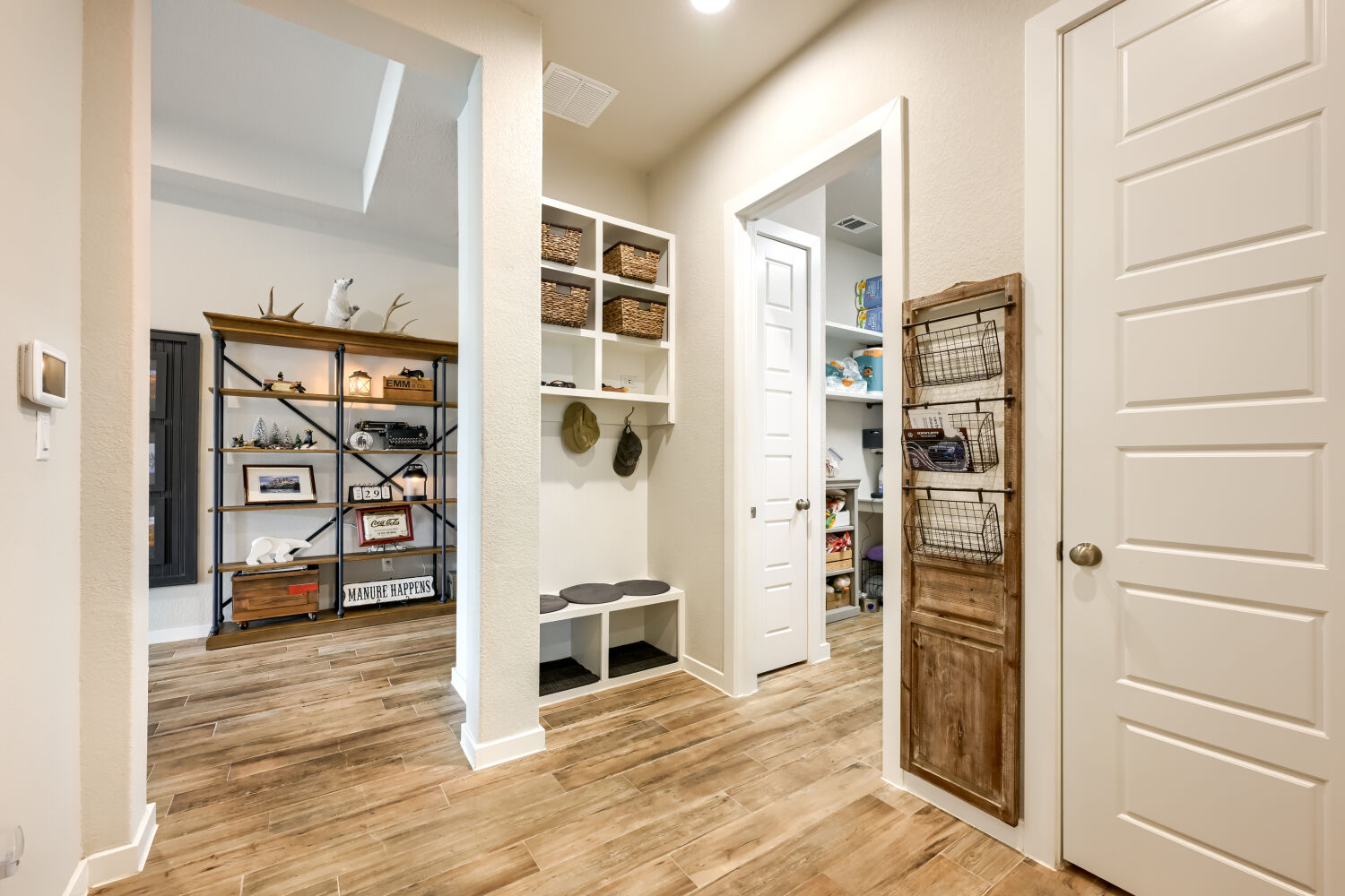 621 Rancho Sienna Loop Georgetown, TX 78628 - Photo 17 of 28 Hardwood-style flooring extends through this functional mudroom and pantry entryway.