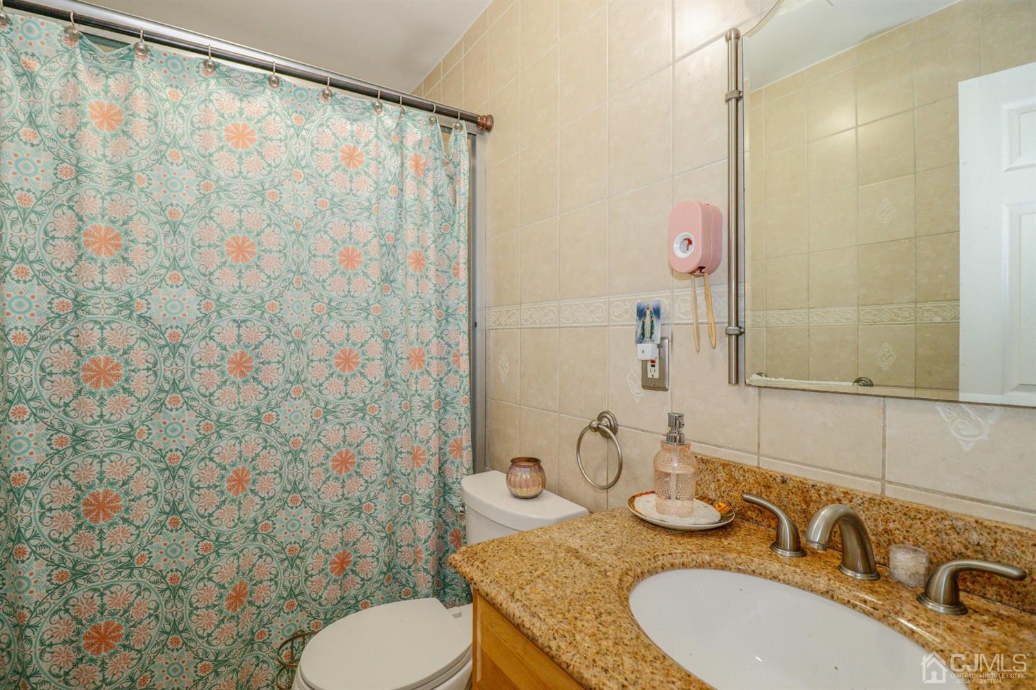 23 Matson Road Edison, NJ 08817 - Photo 13 of 28 a bathroom with a granite countertop sink and a mirror