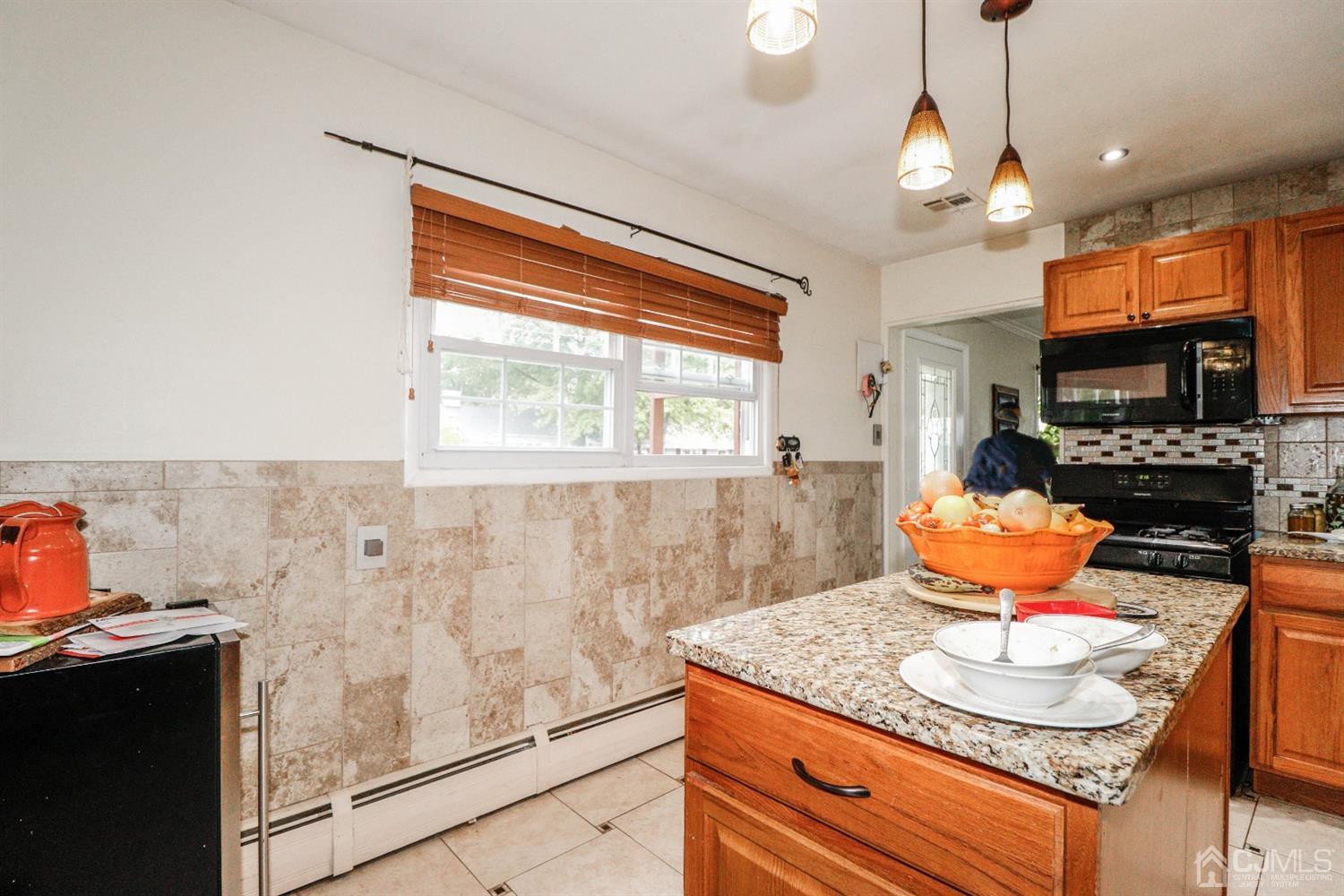 23 Matson Road Edison, NJ 08817 - Photo 16 of 28 a kitchen with stainless steel appliances granite countertop a stove a sink and a microwave