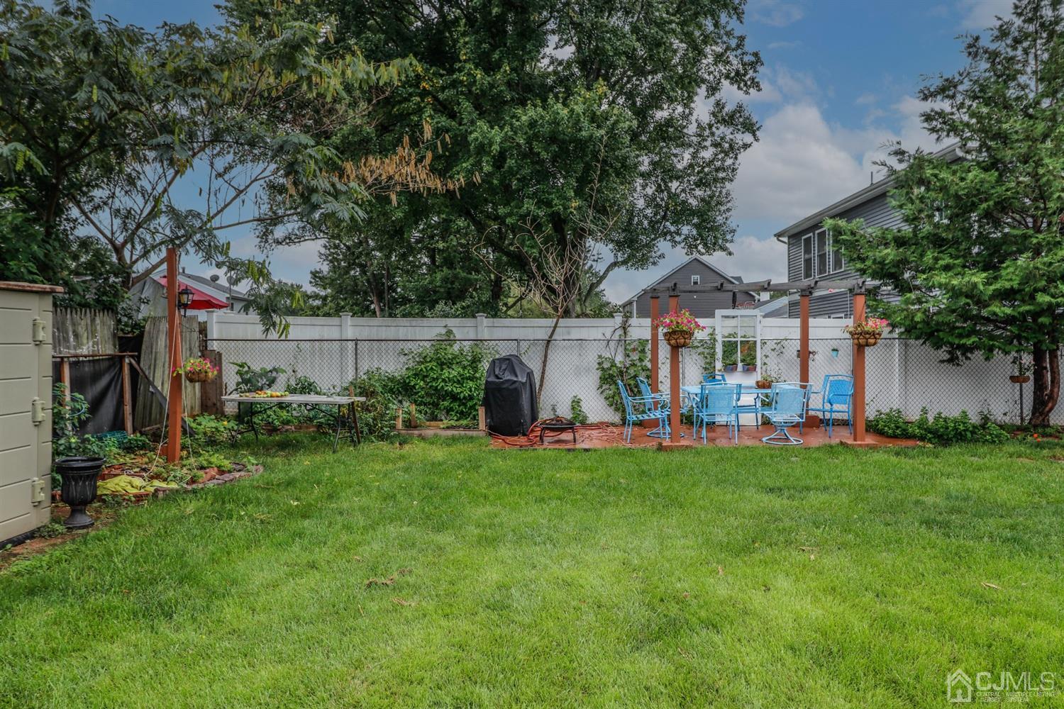 23 Matson Road Edison, NJ 08817 - Photo 25 of 28 a front view of a house with a garden and trees