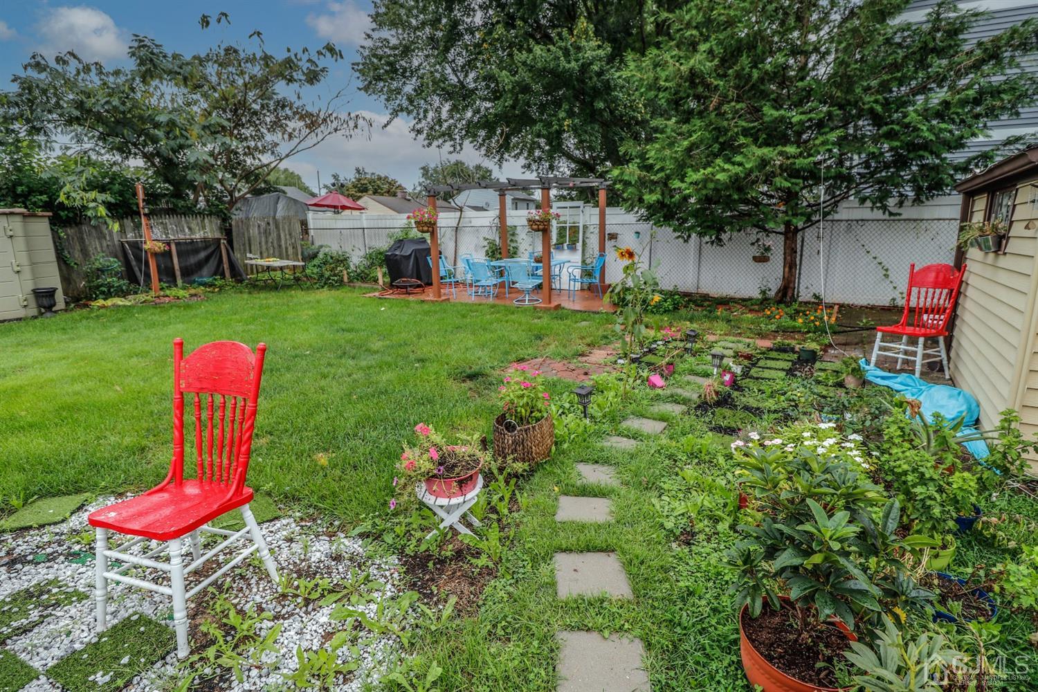 23 Matson Road Edison, NJ 08817 - Photo 28 of 28 a view of a backyard with table and chairs and potted plants