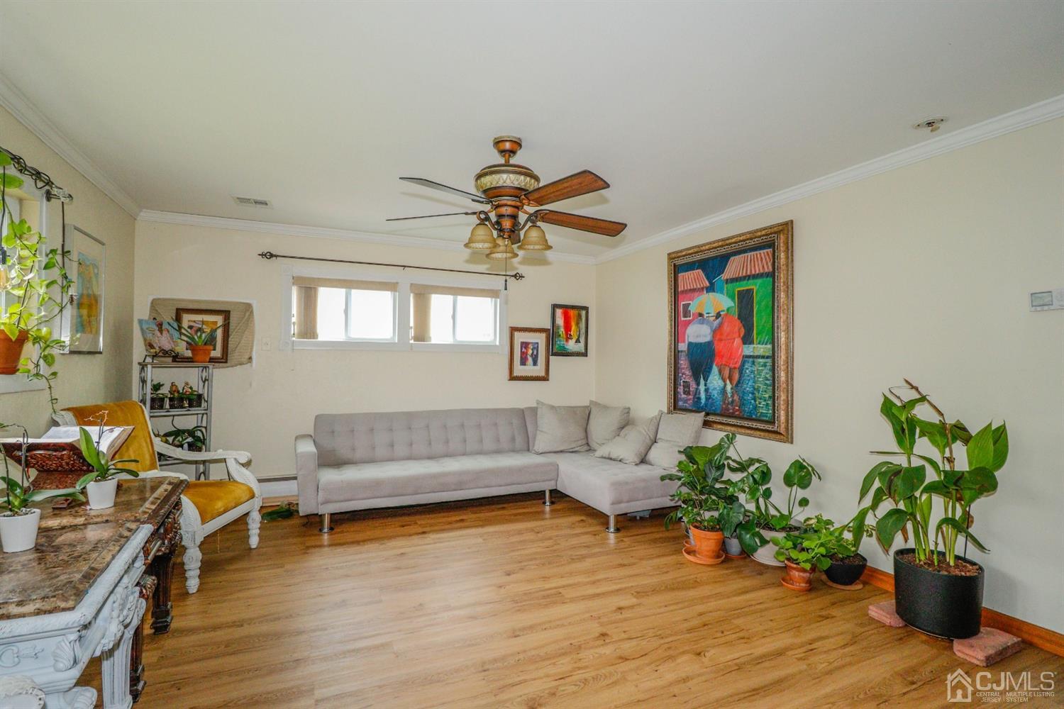 23 Matson Road Edison, NJ 08817 - Photo 6 of 28 a living room with furniture flowers and a potted plant