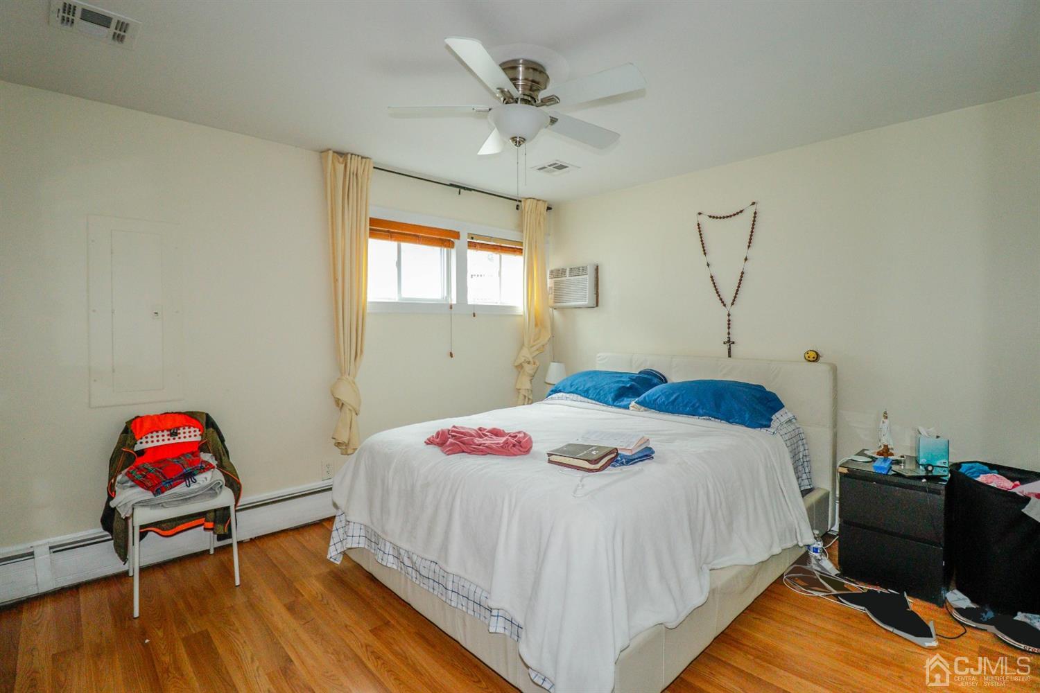 23 Matson Road Edison, NJ 08817 - Photo 9 of 28 a bedroom with a bed and wooden floor