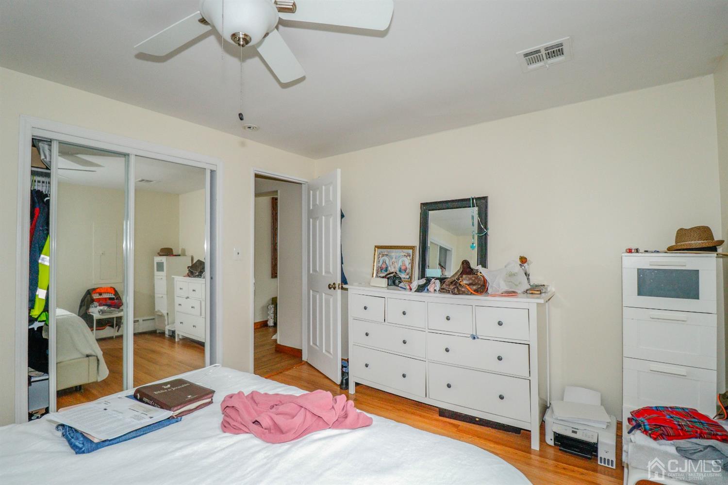 23 Matson Road Edison, NJ 08817 - Photo 10 of 28 a bedroom with a bed and wooden floor