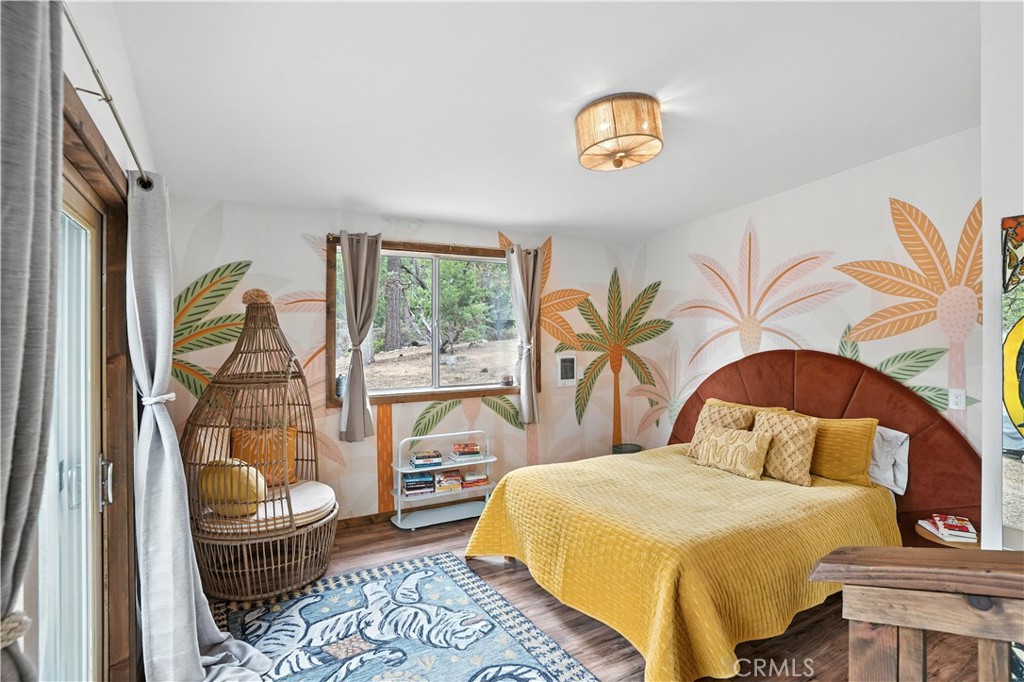 24990 Marion Ridge Drive Idyllwild, CA 92549 - Photo 13 of 41 a bedroom with a bed and a painting on the wall